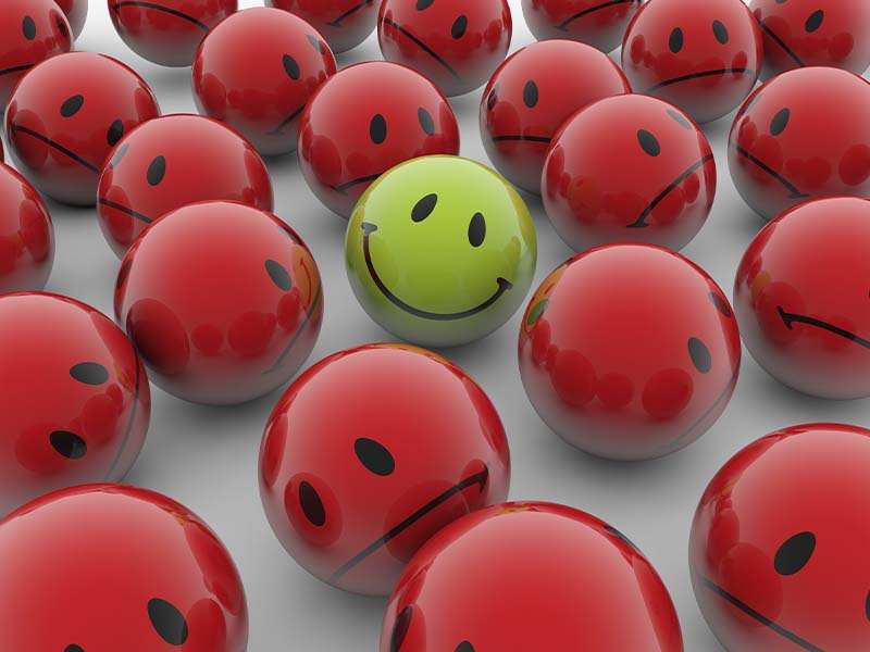saap-800_0000_3d-rendering-illustration-red-balls-with-sad-emotions-green-happy-one-white-surface